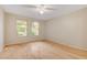 Bedroom with hardwood flooring and windows that look out to the front yard at 5373 Painted Mirage Rd, Las Vegas, NV 89149