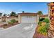 Charming single-story home featuring a two-car garage, tile roof, and attractive landscaping at 5373 Painted Mirage Rd, Las Vegas, NV 89149