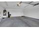Spacious garage with ample room for parking and storage with equipment on shelves at 5373 Painted Mirage Rd, Las Vegas, NV 89149