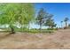 Scenic view of a lush green golf course with mature trees and manicured lawns on a bright, sunny day at 5373 Painted Mirage Rd, Las Vegas, NV 89149