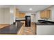 Well lit kitchen features black appliances, tile countertops, and wood cabinets at 5373 Painted Mirage Rd, Las Vegas, NV 89149