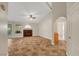 Bright living room with tiled floors, a fireplace, large windows, and a ceiling fan at 5373 Painted Mirage Rd, Las Vegas, NV 89149