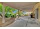 Covered patio area that features a stone landscaping with shade trees, grill, and stucco wall at 5373 Painted Mirage Rd, Las Vegas, NV 89149