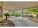 Charming backyard featuring a covered patio, surrounded by mature trees and gravel landscaping at 5373 Painted Mirage Rd, Las Vegas, NV 89149