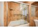 Shower/tub combo in the bathroom with decorative tile and safety bar at 5516 Orchard Ln # 0, Las Vegas, NV 89110