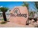 A large stone sign for The Arbors community, surrounded by desert landscaping and blue skies at 5516 Orchard Ln # 0, Las Vegas, NV 89110