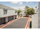 Exterior view of condo building with garages, landscaping, and community pool access for convenient living at 5516 Orchard Ln # 0, Las Vegas, NV 89110