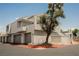 Modern condo building with attached garages, clean lines, and desert landscaping for a stylish curb appeal at 5516 Orchard Ln # 0, Las Vegas, NV 89110