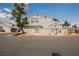 Exterior view of condo building with assigned parking, landscaping, and community pool access at 5516 Orchard Ln # 0, Las Vegas, NV 89110