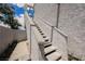 Outdoor staircase leading to the upper-level condos, surrounded by greenery at 5516 Orchard Ln # 0, Las Vegas, NV 89110