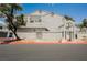 Exterior view of condo building with assigned parking, landscaping, and community pool access at 5516 Orchard Ln # 0, Las Vegas, NV 89110