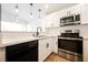 Modern kitchen featuring stainless steel appliances, quartz countertops and view of living room at 5516 Orchard Ln # 0, Las Vegas, NV 89110