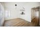 Living room showing hardwood floors, modern lighting and open layout to the kitchen at 5516 Orchard Ln # 0, Las Vegas, NV 89110