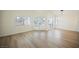 Spacious living room featuring modern lighting, hardwood floors and access to the patio at 5516 Orchard Ln # 0, Las Vegas, NV 89110