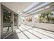 A private patio with light-colored pergolas overtop and natural sunlight shining through at 5516 Orchard Ln # 0, Las Vegas, NV 89110