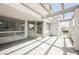 Large patio with light concrete floor and access to the living area through glass doors at 5516 Orchard Ln # 0, Las Vegas, NV 89110