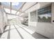 View of a large, outdoor patio, featuring a light-colored concrete floor and a white facade at 5516 Orchard Ln # 0, Las Vegas, NV 89110