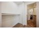 Walk-in closet with shelving, leading to an adjacent bathroom with tile accents at 5516 Orchard Ln # 0, Las Vegas, NV 89110