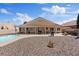 Backyard with a sparkling pool, desert landscaping, and patio at 5812 Spinnaker Reach Ave, Las Vegas, NV 89130