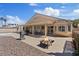 Backyard featuring a covered patio, fire pit, and desert landscaping at 5812 Spinnaker Reach Ave, Las Vegas, NV 89130