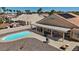 Aerial of a backyard featuring a pool, covered patio, and desert landscape, perfect for outdoor enjoyment at 5812 Spinnaker Reach Ave, Las Vegas, NV 89130