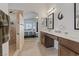 Bathroom featuring hardwood floors, an arched entrance into the bedroom, and double sinks at 5812 Spinnaker Reach Ave, Las Vegas, NV 89130