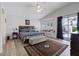 Bright bedroom featuring a ceiling fan, hardwood floors, and a sitting space at 5812 Spinnaker Reach Ave, Las Vegas, NV 89130