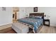 Bright bedroom featuring hardwood floors and an entrance into a bathroom at 5812 Spinnaker Reach Ave, Las Vegas, NV 89130