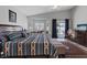 Bright bedroom featuring a ceiling fan, hardwood floors, and a sitting space at 5812 Spinnaker Reach Ave, Las Vegas, NV 89130