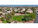Aerial view of a community park surrounded by homes, with a green lawn, trees, and desert landscaping at 5812 Spinnaker Reach Ave, Las Vegas, NV 89130