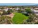 Aerial view showcases a community park featuring lush green space and trees, nestled among residential homes at 5812 Spinnaker Reach Ave, Las Vegas, NV 89130