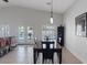 Dining room with backyard views, light walls, tile flooring and modern light fixture at 5812 Spinnaker Reach Ave, Las Vegas, NV 89130