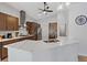 Modern kitchen with stainless appliances, island with sink and beautiful stone countertops at 5812 Spinnaker Reach Ave, Las Vegas, NV 89130