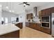 Large kitchen features stainless steel appliances, gas range, quartz counters and eat-in island at 5812 Spinnaker Reach Ave, Las Vegas, NV 89130