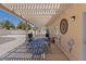 Covered patio with outdoor furniture, barbecue, and pool views at 5812 Spinnaker Reach Ave, Las Vegas, NV 89130