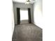 Bright bedroom with neutral carpet, curtains, and natural light at 6450 Spring Jog St, Las Vegas, NV 89166