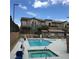Inviting community pool and hot tub surrounded by comfortable lounge chairs and shade at 6450 Spring Jog St, Las Vegas, NV 89166