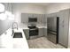 Modern kitchen with stainless steel appliances, including a refrigerator and a range at 6450 Spring Jog St, Las Vegas, NV 89166
