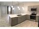 Fully equipped kitchen with a central island, stainless steel appliances, and modern fixtures at 6450 Spring Jog St, Las Vegas, NV 89166