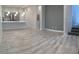 Open-concept living area with tile flooring, bright lighting, and a staircase to the upper level at 6450 Spring Jog St, Las Vegas, NV 89166
