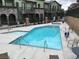 Community pool and spa surrounded by multi-story buildings at 6450 Spring Jog St, Las Vegas, NV 89166