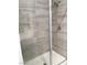 Close-up of a tiled shower with glass doors and modern fixtures at 6450 Spring Jog St, Las Vegas, NV 89166