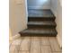 Carpeted steps with landing showcasing modern tiles, blending comfort and style for a welcoming transition at 6450 Spring Jog St, Las Vegas, NV 89166