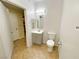 Bathroom with tan tiled floor, gray vanity and plenty of light at 6635 Flaminian Ln # 104, North Las Vegas, NV 89084