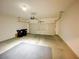 A two car garage with a grey floor mat and black trash bins at 6635 Flaminian Ln # 104, North Las Vegas, NV 89084