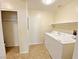 Tiled laundry room featuring full-sized white washer and dryer at 6635 Flaminian Ln # 104, North Las Vegas, NV 89084