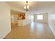 Spacious living room with tile floors and view of the kitchen and balcony access at 6635 Flaminian Ln # 104, North Las Vegas, NV 89084