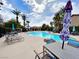 Community pool with palm trees, lounge chairs, and picnic tables at 6635 Flaminian Ln # 104, North Las Vegas, NV 89084