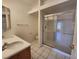 Bathroom featuring a double sink vanity and a walk in shower with glass door at 6908 Dorita Ave # 101, Las Vegas, NV 89108