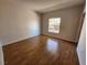 Bright bedroom with hardwood floors and a window providing natural light at 6908 Dorita Ave # 101, Las Vegas, NV 89108
